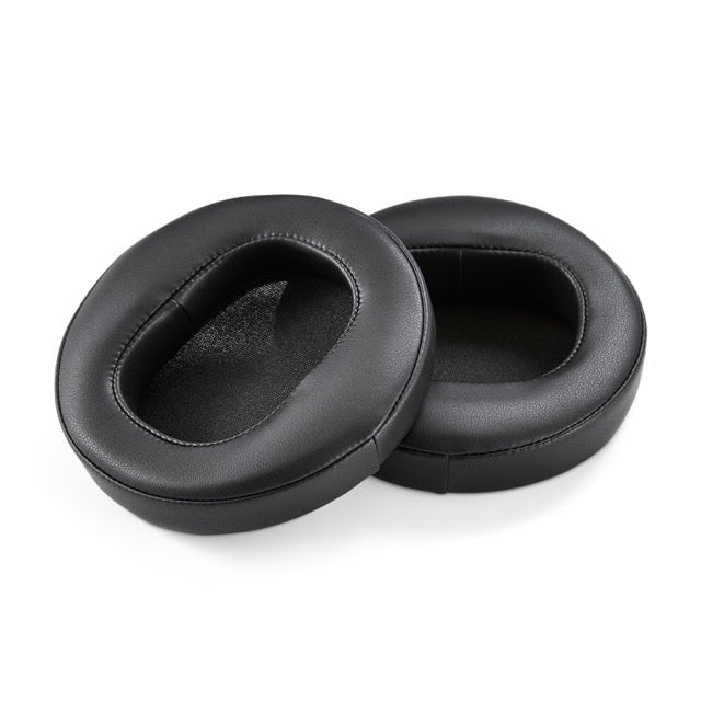 Black leather ear pads for headphones, soft cushioning, ergonomic design for enhanced comfort.