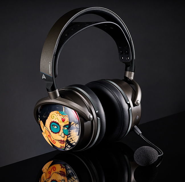 Stylish over-ear headphones with a dark metallic finish and colorful sugar skull design, featuring a microphone.